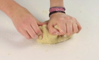 Выкладываем тесто на рабочую поверхность и вымешиваем его руками. Если масса слишком сильно липнет к рукам, то подсыпаем еще немного муки. Месим несколько минут, пока тесто не перестанет липнуть.